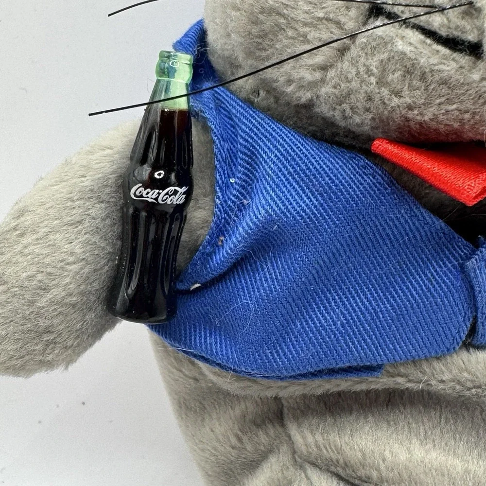 Coca-Cola collectible bean‎ bag plush seal from 1998, wearing a delivery outfit